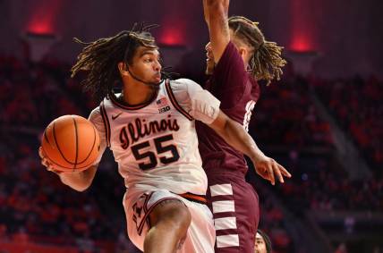 Dec 17, 2022; Champaign, Illinois, USA;  Illinois Fighting Illini guard Skyy Clark (55) drives the ball against Alabama A&M Bulldogs guard Dailin Smith (15) during the first half at State Farm Center. Mandatory Credit: Ron Johnson-USA TODAY Sports