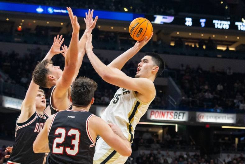 Dec 17, 2022; Indianapolis, Indiana, USA; Purdue Boilermakers center Zach Edey (15) shoots the ball against Davidson Wildcats forward Sam Mennenga (3) in the second half at Gainbridge Fieldhouse. Mandatory Credit: Trevor Ruszkowski-USA TODAY Sports