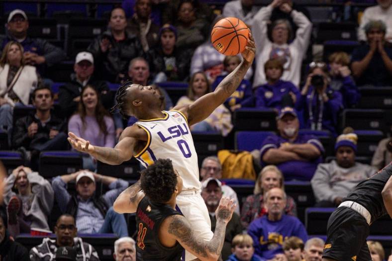 Dec 17, 2022; Baton Rouge, Louisiana, USA;  LSU Tigers guard Trae Hannibal (0) grabs a rebound against Winthrop Eagles guard Kasen Harrison (11) during the second half at Pete Maravich Assembly Center. Mandatory Credit: Stephen Lew-USA TODAY Sports