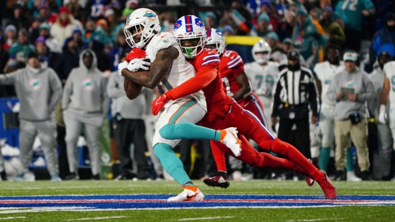 Dec 17, 2022; Orchard Park, New York, USA; Buffalo Bills safety Damar Hamlin (3) tackles Miami Dolphins running back Raheem Mostert (31) running with the ball during the first half at Highmark Stadium. Mandatory Credit: Gregory Fisher-USA TODAY Sports