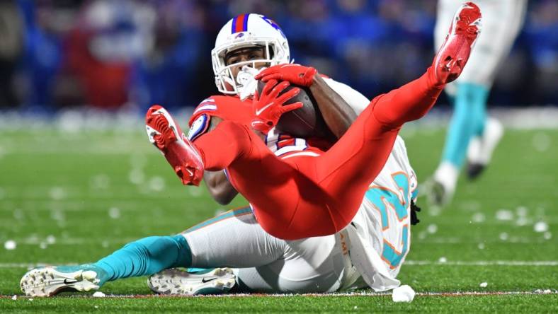 Dec 17, 2022; Orchard Park, New York, USA; Buffalo Bills wide receiver Isaiah McKenzie (6) is tackled by Miami Dolphins cornerback Keion Crossen (27) after a catch in the second quarter at Highmark Stadium. Mandatory Credit: Mark Konezny-USA TODAY Sports