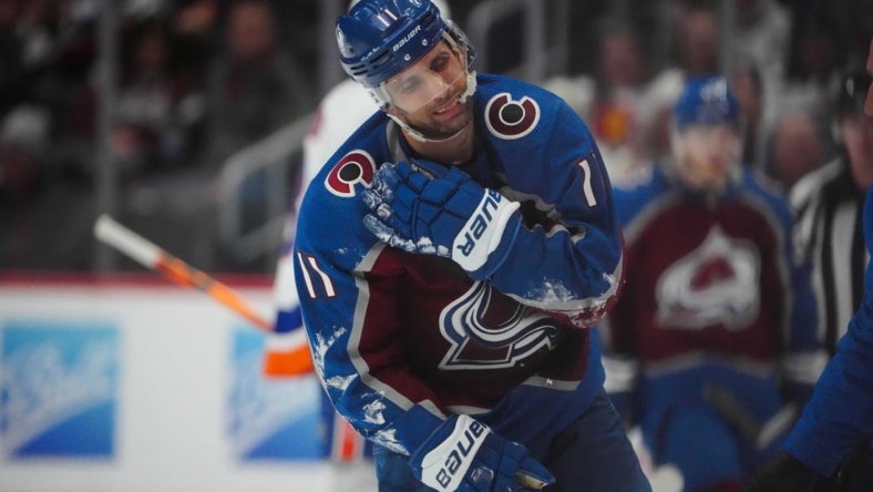 Dec 19, 2022; Denver, Colorado, USA; Colorado Avalanche center Andrew Cogliano (11) leaves the ice due to an injury during the third period against the New York Islanders at Ball Arena. Mandatory Credit: Ron Chenoy-USA TODAY Sports
