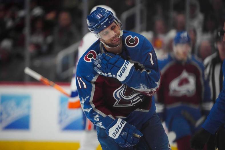 Dec 19, 2022; Denver, Colorado, USA; Colorado Avalanche center Andrew Cogliano (11) leaves the ice due to an injury during the third period against the New York Islanders at Ball Arena. Mandatory Credit: Ron Chenoy-USA TODAY Sports