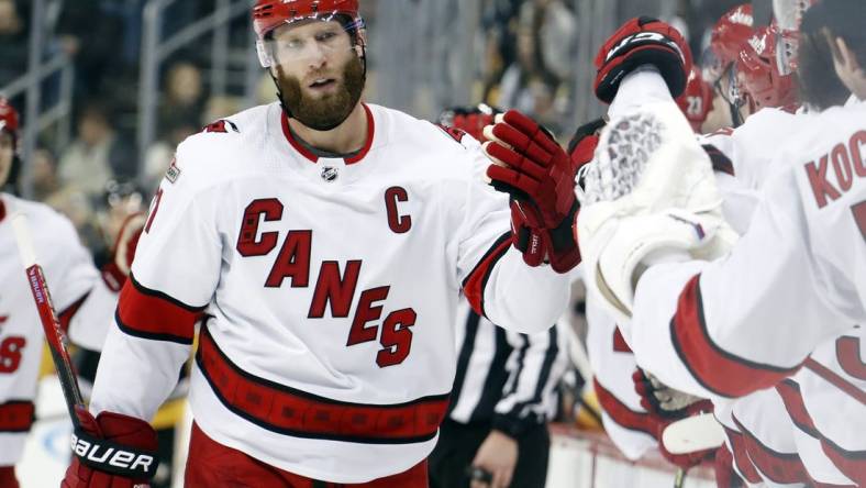 Dec 22, 2022; Pittsburgh, Pennsylvania, USA; Carolina Hurricanes center Jordan Staal (11) celebrates with the Carolina bench after scoring a goal against the Pittsburgh Penguins during the third period at PPG Paints Arena. Carolina won 4-3 in overtime. Mandatory Credit: Charles LeClaire-USA TODAY Sports