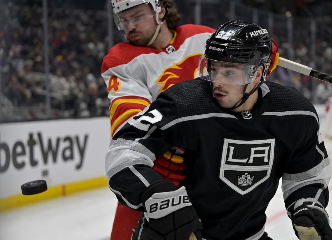 Dec 22, 2022; Los Angeles, California, USA; Calgary Flames defenseman Rasmus Andersson (4) and Los Angeles Kings left wing Kevin Fiala (22) go for the puck in the second period at Crypto.com Arena. Mandatory Credit: Jayne Kamin-Oncea-USA TODAY Sports