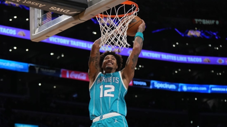 Dec 23, 2022; Los Angeles, California, USA; Charlotte Hornets guard Kelly Oubre Jr. (12) dunks the ball against the Los Angeles Lakers in the first half at Crypto.com Arena. Mandatory Credit: Kirby Lee-USA TODAY Sports