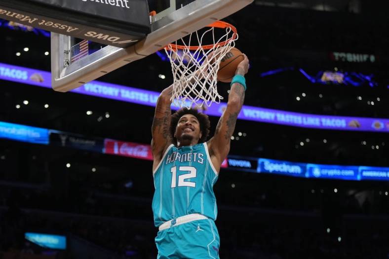 Dec 23, 2022; Los Angeles, California, USA; Charlotte Hornets guard Kelly Oubre Jr. (12) dunks the ball against the Los Angeles Lakers in the first half at Crypto.com Arena. Mandatory Credit: Kirby Lee-USA TODAY Sports