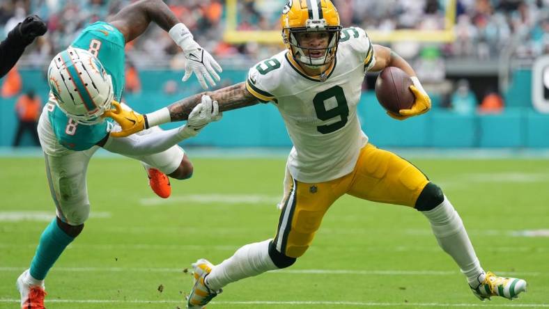 Dec 25, 2022; Miami Gardens, Florida, USA; Miami Dolphins safety Jevon Holland (8) attempts to tackle Green Bay Packers wide receiver Christian Watson (9) during the first half at Hard Rock Stadium. Mandatory Credit: Jasen Vinlove-USA TODAY Sports