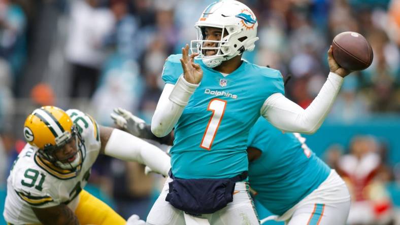 Dec 25, 2022; Miami Gardens, Florida, USA; Miami Dolphins quarterback Tua Tagovailoa (1) throws the football during the fourth quarter against the Green Bay Packers at Hard Rock Stadium. Mandatory Credit: Sam Navarro-USA TODAY Sports