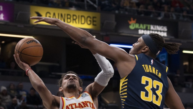 Dec 27, 2022; Indianapolis, Indiana, USA; Indiana Pacers center Myles Turner (33) attempts to block Atlanta Hawks guard Trae Young (11) during the game at Gainbridge Fieldhouse. Mandatory Credit: Armond Feffer-USA TODAY Sports