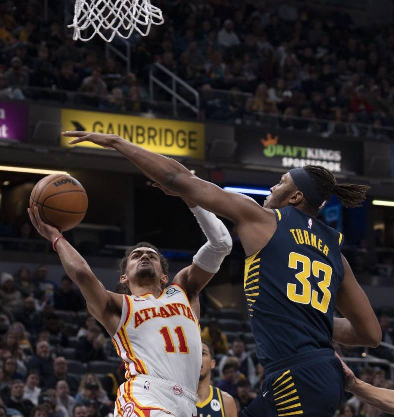 Dec 27, 2022; Indianapolis, Indiana, USA; Indiana Pacers center Myles Turner (33) attempts to block Atlanta Hawks guard Trae Young (11) during the game at Gainbridge Fieldhouse. Mandatory Credit: Armond Feffer-USA TODAY Sports