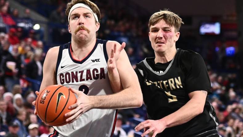 Dec 28, 2022; Spokane, Washington, USA; Gonzaga Bulldogs forward Drew Timme (2) is fouled by Eastern Oregon Mountaineers guard Preston Chandler (5) in the second half at McCarthey Athletic Center. Mandatory Credit: James Snook-USA TODAY Sports