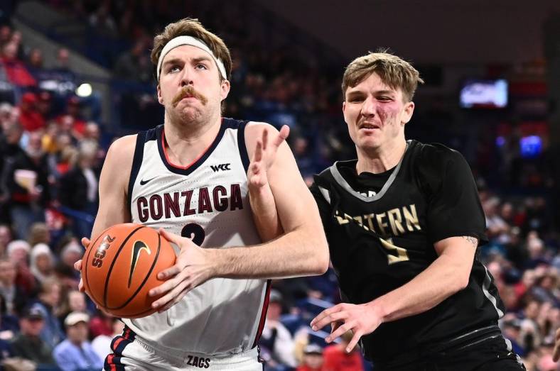 Dec 28, 2022; Spokane, Washington, USA; Gonzaga Bulldogs forward Drew Timme (2) is fouled by Eastern Oregon Mountaineers guard Preston Chandler (5) in the second half at McCarthey Athletic Center. Mandatory Credit: James Snook-USA TODAY Sports