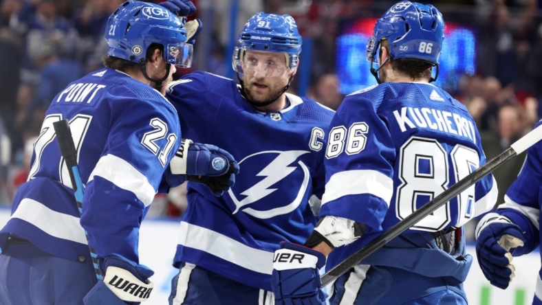 Dec 28, 2022; Tampa, Florida, USA;Tampa Bay Lightning center Brayden Point (21) is congratulated by center Steven Stamkos (91) and right wing Nikita Kucherov (86) after he scored a goal against the Montreal Canadiens  during the first period at Amalie Arena. Mandatory Credit: Kim Klement-USA TODAY Sports