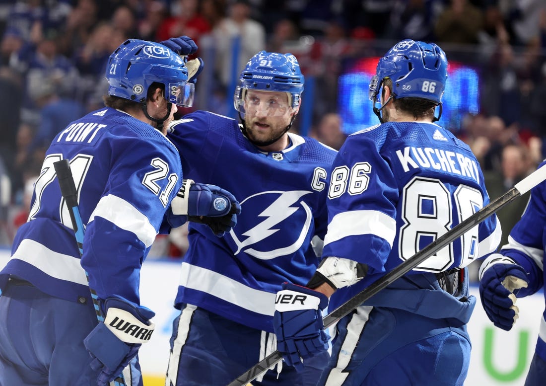 Dec 28, 2022; Tampa, Florida, USA;Tampa Bay Lightning center Brayden Point (21) is congratulated by center Steven Stamkos (91) and right wing Nikita Kucherov (86) after he scored a goal against the Montreal Canadiens  during the first period at Amalie Arena. Mandatory Credit: Kim Klement-USA TODAY Sports