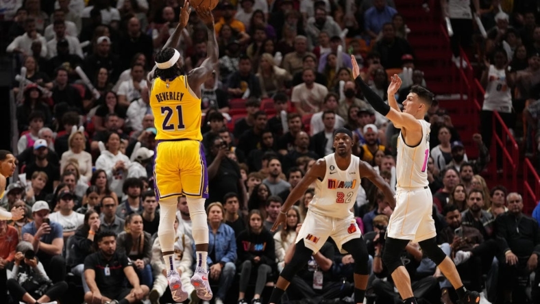 Dec 28, 2022; Miami, Florida, USA; Los Angeles Lakers guard Patrick Beverley (21) attempts a three point shot over Miami Heat guard Tyler Herro (14) during the second half at FTX Arena. Mandatory Credit: Jasen Vinlove-USA TODAY Sports