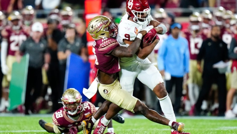Dec 29, 2022; Orlando, Florida, USA; Florida State Seminoles defensive back Jammie Robinson (10) tackles Oklahoma Sooners tight end Brayden Willis (9) during the second half in the 2022 Cheez-It Bowl at Camping World Stadium. Mandatory Credit: Rich Storry-USA TODAY Sports