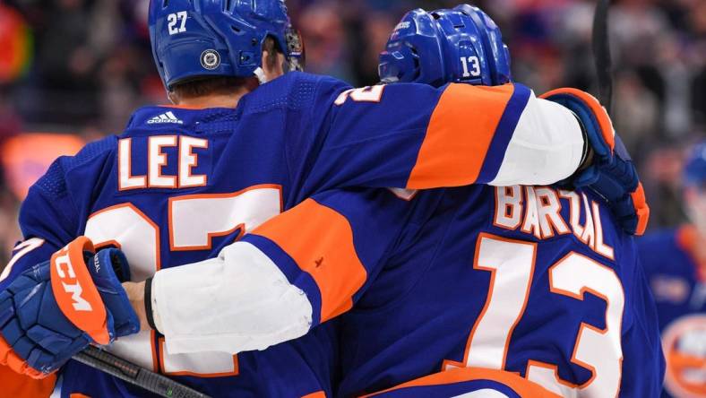 Dec 29, 2022; Elmont, New York, USA; New York Islanders left wing Anders Lee (27) celebrates the goal by center Mathew Barzal (13) against the Columbus Blue Jackets during the second period at UBS Arena. Mandatory Credit: Dennis Schneidler-USA TODAY Sports