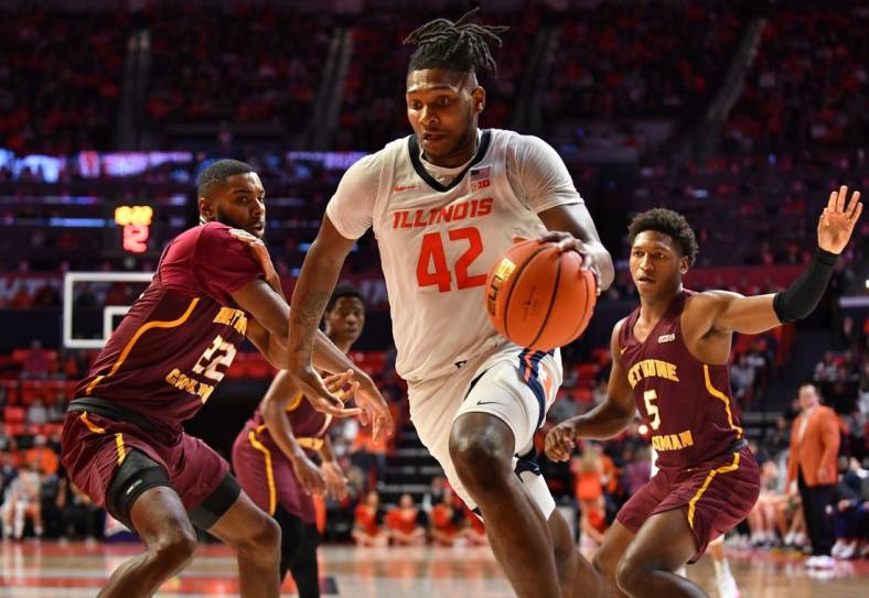 Dec 29, 2022; Champaign, Illinois, USA;  Illinois Fighting Illini forward Dain Dainja (42) drives ball past Bethune-Cookman Wildcats center Dylan Robertson (22) during the first half at State Farm Center. Mandatory Credit: Ron Johnson-USA TODAY Sports