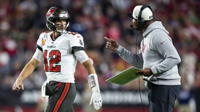 Dec 25, 2022; Glendale, Arizona, USA; Tampa Bay Buccaneers quarterback Tom Brady (12) with offensive coordinator Byron Leftwich against the Arizona Cardinals at State Farm Stadium. Mandatory Credit: Mark J. Rebilas-USA TODAY Sports