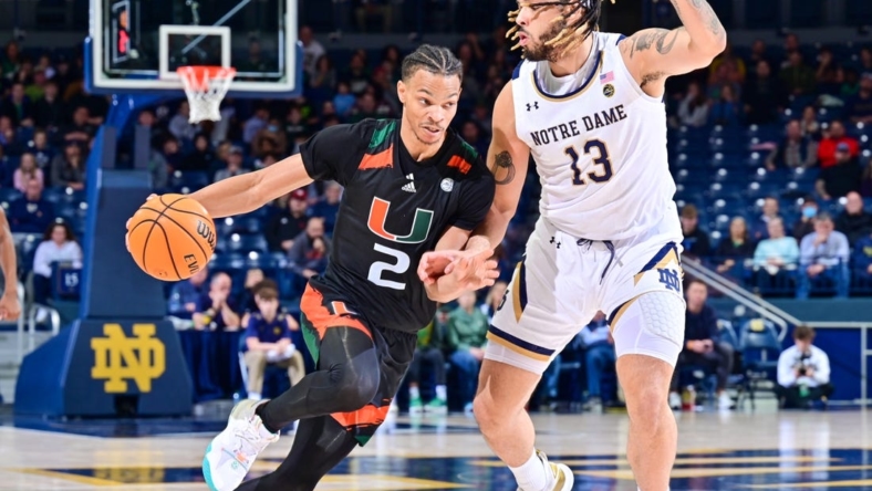 Dec 30, 2022; South Bend, Indiana, USA; Miami Hurricanes guard Isaiah Wong (2) dribbles as Notre Dame Fighting Irish forward Dom Campbell (13) defends in the second half at the Purcell Pavilion. Mandatory Credit: Matt Cashore-USA TODAY Sports