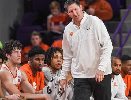 Dec 30, 2022; Clemson, South Carolina, USA; Clemson Head Coach Brad Brownell talks with sophomore forward PJ Hall (24) as the team plays North Carolina State Wolfpack during the first half at Littlejohn Coliseum. Mandatory Credit: Ken Ruinard-USA TODAY Sports