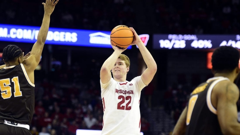 Dec 30, 2022; Madison, Wisconsin, USA; Wisconsin Badgers forward Steven Crowl (22) shoots a three-pointer against Western Michigan Broncos guard Jefferson Monegro (5) during the second half at the Kohl Center. Mandatory Credit: Kayla Wolf-USA TODAY Sports