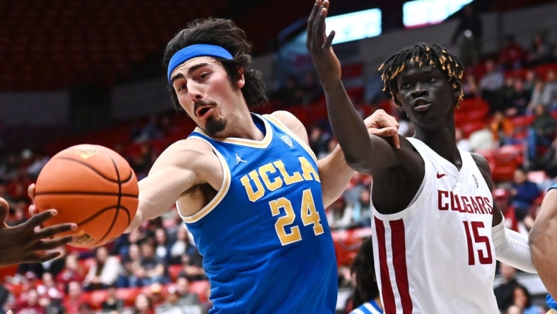 Dec 30, 2022; Pullman, Washington, USA; UCLA Bruins guard Jaime Jaquez Jr. (24) rebounds the ball against Washington State Cougars center Adrame Diongue (15) in the first half at Friel Court at Beasley Coliseum. Mandatory Credit: James Snook-USA TODAY Sports