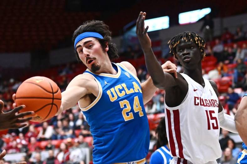 Dec 30, 2022; Pullman, Washington, USA; UCLA Bruins guard Jaime Jaquez Jr. (24) rebounds the ball against Washington State Cougars center Adrame Diongue (15) in the first half at Friel Court at Beasley Coliseum. Mandatory Credit: James Snook-USA TODAY Sports