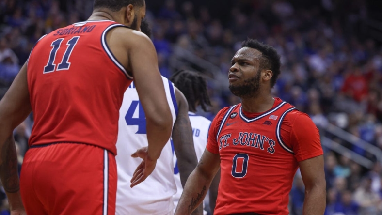 Dec 31, 2022; Newark, New Jersey, USA; St. John's Red Storm guard Posh Alexander (0) reacts after a basket by center Joel Soriano (11) during the first half against the Seton Hall Pirates at Prudential Center. Mandatory Credit: Vincent Carchietta-USA TODAY Sports