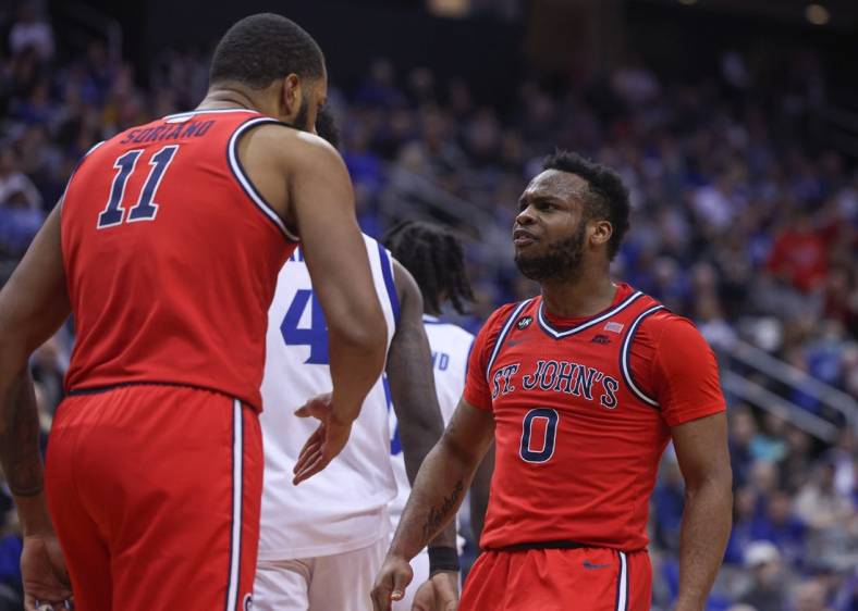 Dec 31, 2022; Newark, New Jersey, USA; St. John's Red Storm guard Posh Alexander (0) reacts after a basket by center Joel Soriano (11) during the first half against the Seton Hall Pirates at Prudential Center. Mandatory Credit: Vincent Carchietta-USA TODAY Sports