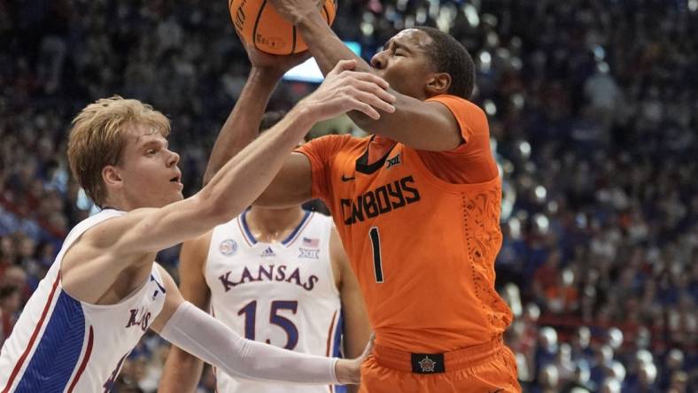 Dec 31, 2022; Lawrence, Kansas, USA; Oklahoma State Cowboys guard Bryce Thompson (1) shoots and is fouled by Kansas Jayhawks guard Gradey Dick (4) during the first half at Allen Fieldhouse. Mandatory Credit: Denny Medley-USA TODAY Sports