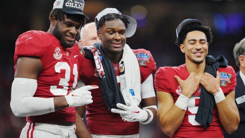 Dec 31, 2022; New Orleans, LA, USA; Alabama Crimson Tide linebacker Will Anderson Jr. (31) defensive back Jordan Battle (9) and quarterback Bryce Young (9) celebrate the victory against the Kansas State Wildcats in the 2022 Sugar Bowl at Caesars Superdome. Mandatory Credit: Andrew Wevers-USA TODAY Sports