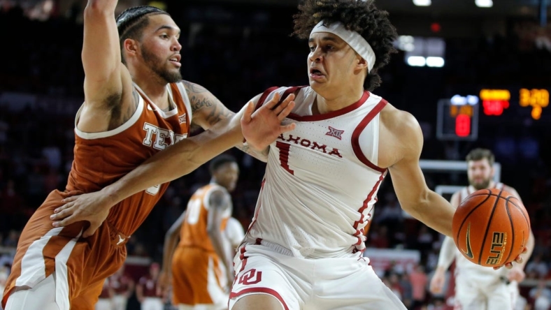 Oklahoma Sooners forward Jalen Hill (1) tries top get past Texas Longhorns forward Timmy Allen (0) during an NCAA men's college basketball game between the University of Oklahoma and Texas at Lloyd Noble Center in Norman, Okla., Saturday, Dec. 31, 2022. Texas won 70-69.

Oklahoma Vs Texas Basketball