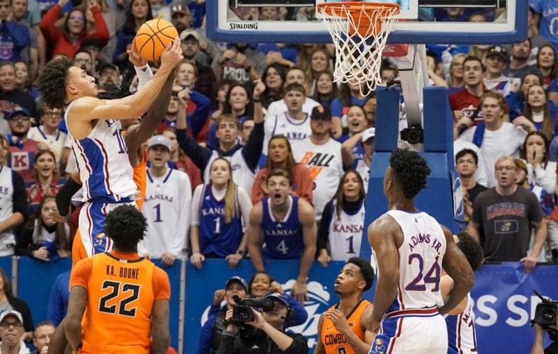 Dec 31, 2022; Lawrence, Kansas, USA; Kansas Jayhawks forward Jalen Wilson (10) rebounds against the Oklahoma State Cowboys during the second half at Allen Fieldhouse. Mandatory Credit: Denny Medley-USA TODAY Sports