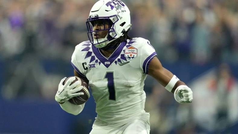 Dec 31, 2022; Glendale, Arizona, USA; TCU Horned Frogs wide receiver Quentin Johnston (1) runs after a catch in the second quarter against the Michigan Wolverines of the 2022 Fiesta Bowl at State Farm Stadium. Mandatory Credit: Kirby Lee-USA TODAY Sports