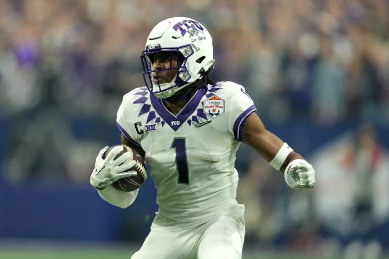 Dec 31, 2022; Glendale, Arizona, USA; TCU Horned Frogs wide receiver Quentin Johnston (1) runs after a catch in the second quarter against the Michigan Wolverines of the 2022 Fiesta Bowl at State Farm Stadium. Mandatory Credit: Kirby Lee-USA TODAY Sports