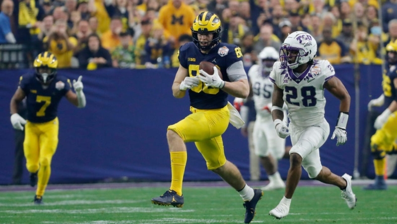 Michigan tight end Luke Schoonmaker (86) runs after a reception while TCU safety Millard Bradford (28) chases during the first quarter of the Fiesta Bowl on Saturday, Dec. 31 at State Farm Stadium in Glendale, Ariz.

2022-12-31-michigan-fiesta