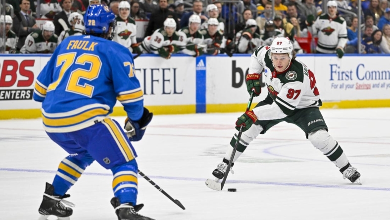Dec 31, 2022; St. Louis, Missouri, USA;  Minnesota Wild left wing Kirill Kaprizov (97) controls the puck as St. Louis Blues defenseman Justin Faulk (72) defends during the first period at Enterprise Center. Mandatory Credit: Jeff Curry-USA TODAY Sports