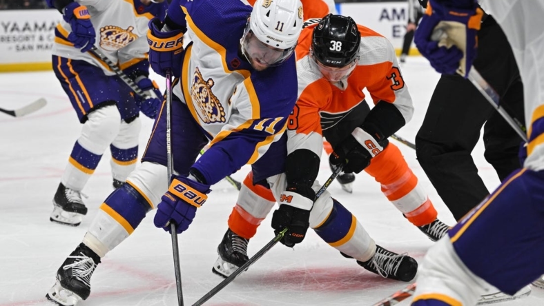 Dec 31, 2022; Los Angeles, California, USA;  Los Angeles Kings center Anze Kopitar (11) and Philadelphia Flyers center Patrick Brown (38) face off in the third period at Crypto.com Arena. Mandatory Credit: Jayne Kamin-Oncea-USA TODAY Sports