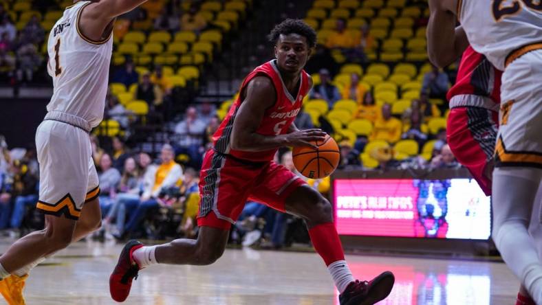 Dec 31, 2022; Laramie, Wyoming, USA; New Mexico Lobos guard Jamal Mashburn Jr. (5) drives against the Wyoming Cowboys during the first half at Arena-Auditorium. Mandatory Credit: Troy Babbitt-USA TODAY Sports