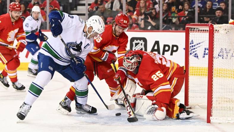 Dec 31, 2022; Calgary, Alberta, CAN; Vancouver Canucks forward Bo Horvat (53) shoots the puck against goalie Jacob Markstrom (25) during the second period at Scotiabank Saddledome. Mandatory Credit: Candice Ward-USA TODAY Sports