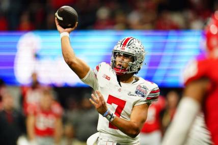 Dec 31, 2022; Atlanta, Georgia, USA; Ohio State Buckeyes quarterback C.J. Stroud (7) passes the ball against the Georgia Bulldogs during the third quarter of the 2022 Peach Bowl at Mercedes-Benz Stadium. Mandatory Credit: John David Mercer-USA TODAY Sports