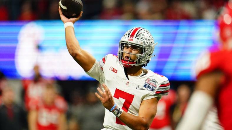 Dec 31, 2022; Atlanta, Georgia, USA; Ohio State Buckeyes quarterback C.J. Stroud (7) passes the ball against the Georgia Bulldogs during the third quarter of the 2022 Peach Bowl at Mercedes-Benz Stadium. Mandatory Credit: John David Mercer-USA TODAY Sports