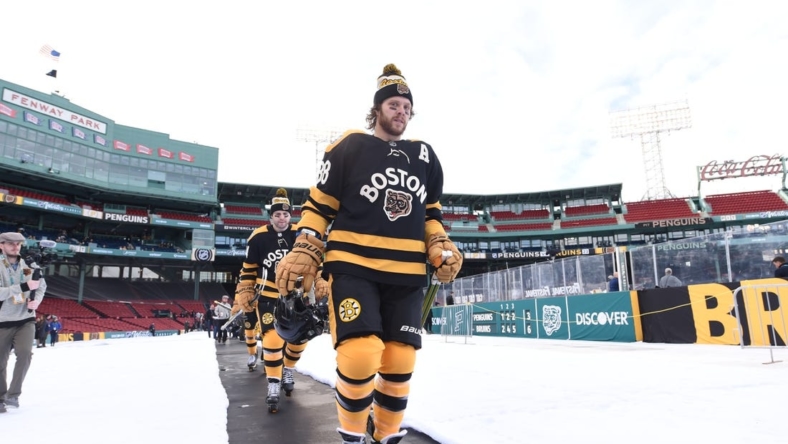 Jan 1, 2023; Boston, MA, USA; Boston Bruins right wing David Pastrnak (88) walks to the ice during a practice day before the 2023 Winter Classic ice hockey game at Fenway Park. Mandatory Credit: Bob DeChiara-USA TODAY Sports