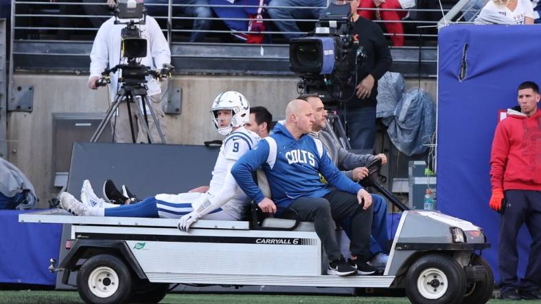 Jan 1, 2023; East Rutherford, New Jersey, USA; Indianapolis Colts quarterback Nick Foles (9) is driven off the field after an injury during the first half against the New York Giants at MetLife Stadium. Mandatory Credit: Vincent Carchietta-USA TODAY Sports