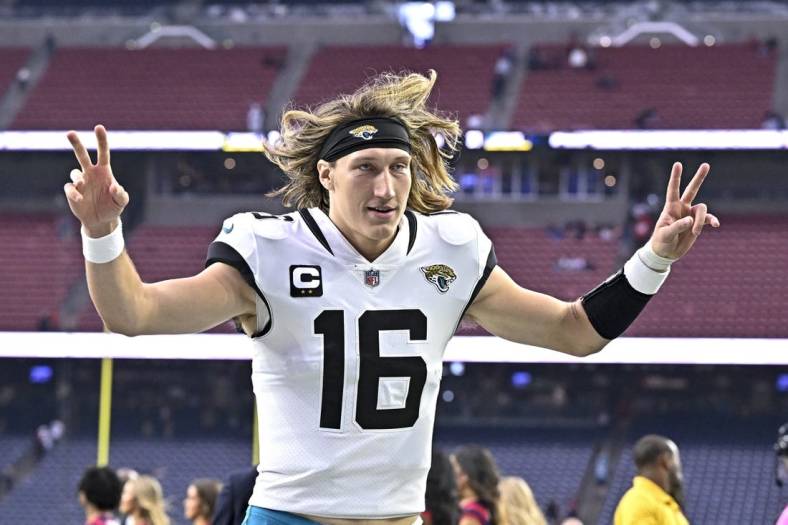 Jan 1, 2023; Houston, Texas, USA;  Jacksonville Jaguars quarterback Trevor Lawrence (16) reacts as he leaves the field after the win against the Houston Texans at NRG Stadium. Mandatory Credit: Maria Lysaker-USA TODAY Sports