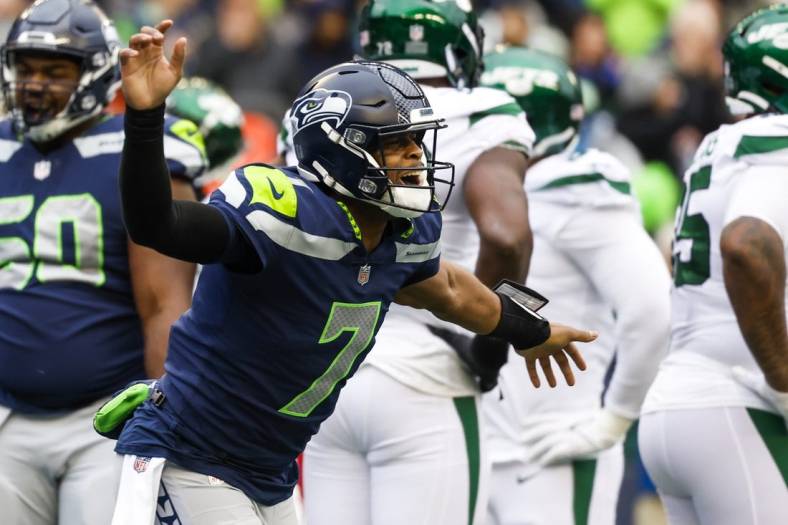 Jan 1, 2023; Seattle, Washington, USA; Seattle Seahawks quarterback Geno Smith (7) celebrates after showing a touchdown pass against the New York Jets during the second quarter at Lumen Field. Mandatory Credit: Joe Nicholson-USA TODAY Sports