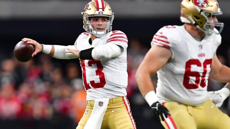 January 1, 2023; Paradise, Nevada, USA; San Francisco 49ers quarterback Brock Purdy (13) throws as offensive tackle Daniel Brunskill (60) provides coverage against the Las Vegas Raiders during the first half at Allegiant Stadium. Mandatory Credit: Gary A. Vasquez-USA TODAY Sports