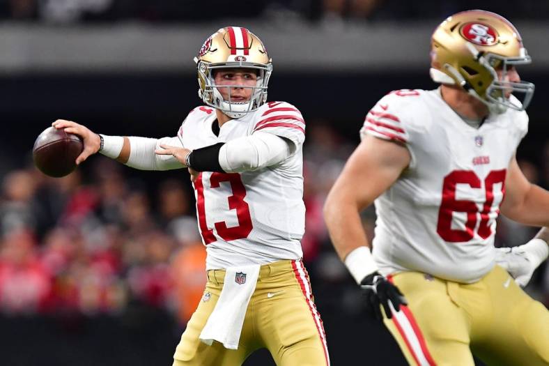 January 1, 2023; Paradise, Nevada, USA; San Francisco 49ers quarterback Brock Purdy (13) throws as offensive tackle Daniel Brunskill (60) provides coverage against the Las Vegas Raiders during the first half at Allegiant Stadium. Mandatory Credit: Gary A. Vasquez-USA TODAY Sports